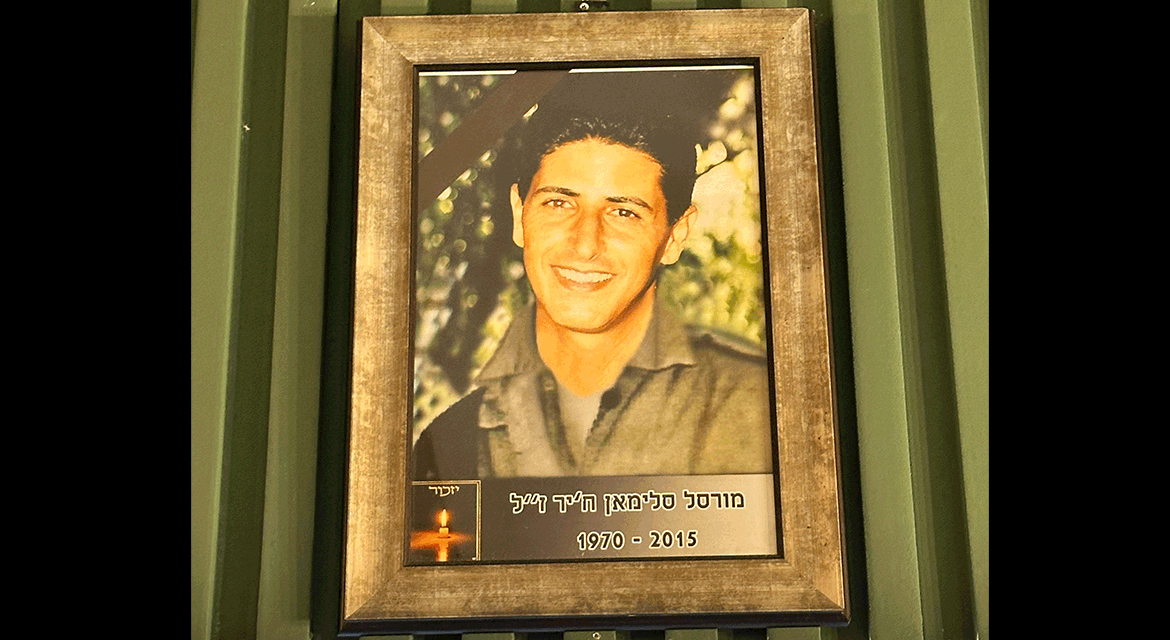 UJA Federation of New York >> <p><em>A photo of Basma's late husband hangs in her restaurant.</em></p>
